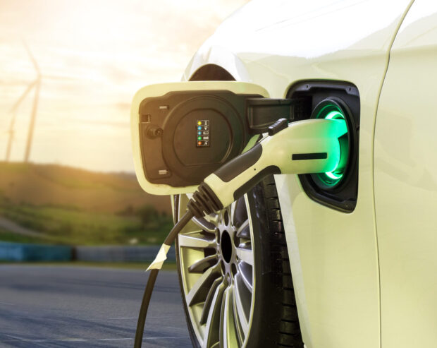 Electric,Car,Or,Ev,Car,Charging,In,Station,On,Blurred